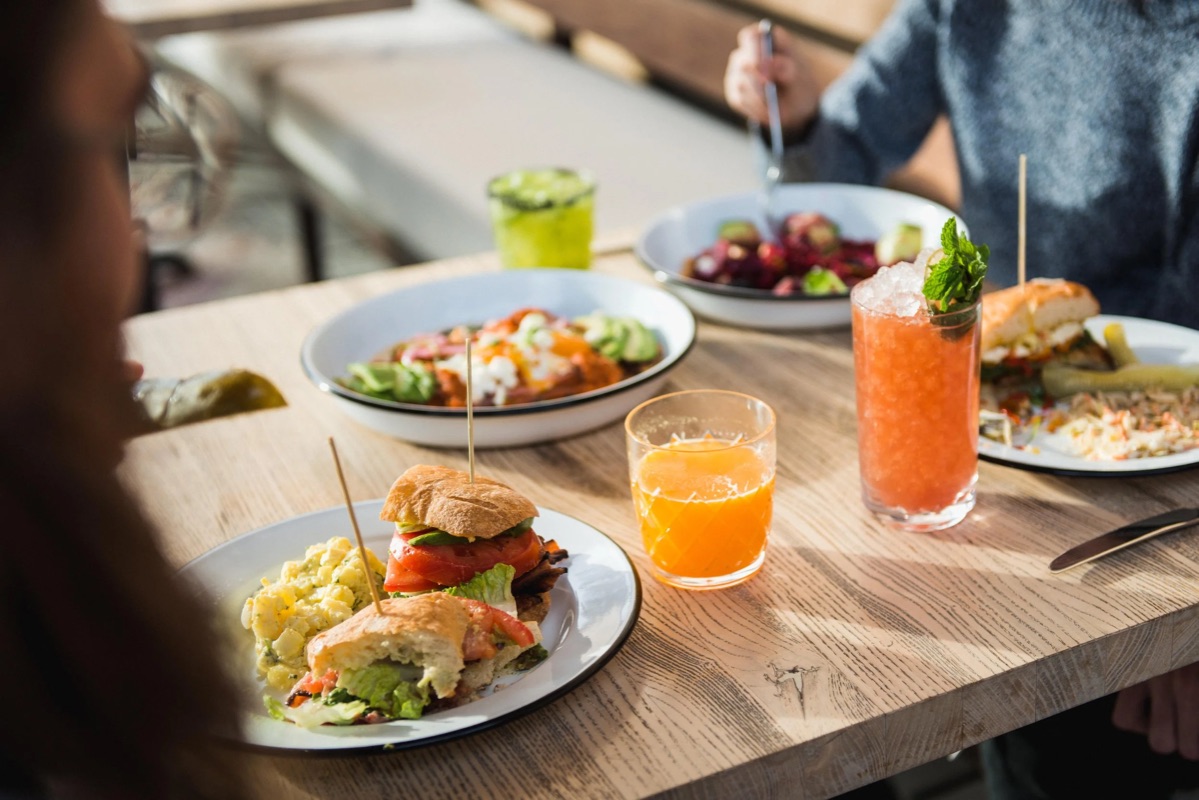 Food photography — a brunch spread of sandwiches and fresh drinks